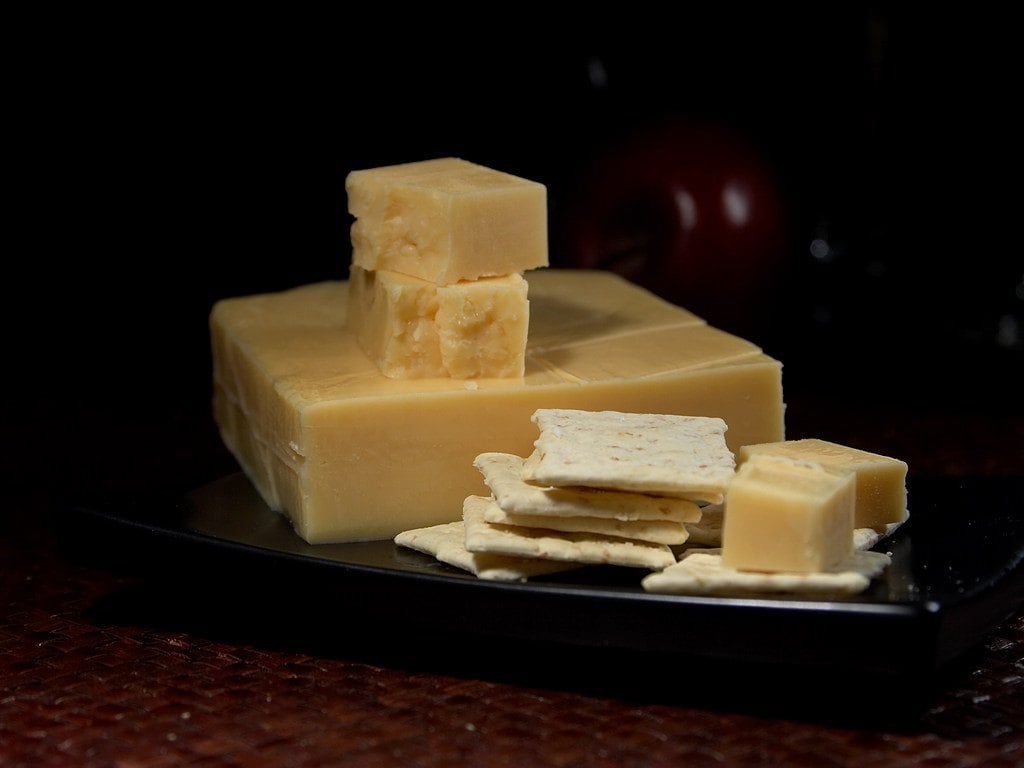 Pieces of Edam Cheese on the black plate