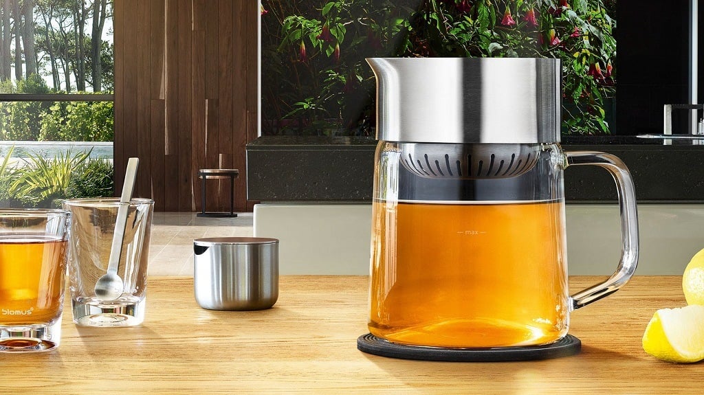 Iced Tea Maker, cups, a spoon and sliced lemon on the table