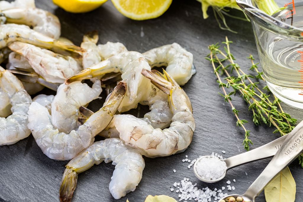 Fresh Shrimp, slices of lemon, vegetables and spoons of spices