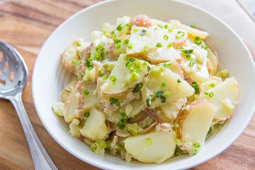 A plate of Potato Salad and a fork on the table