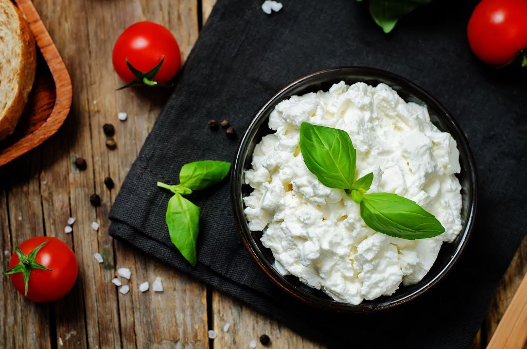 A bowl of Ricotta Cheese and tomatoes on the table