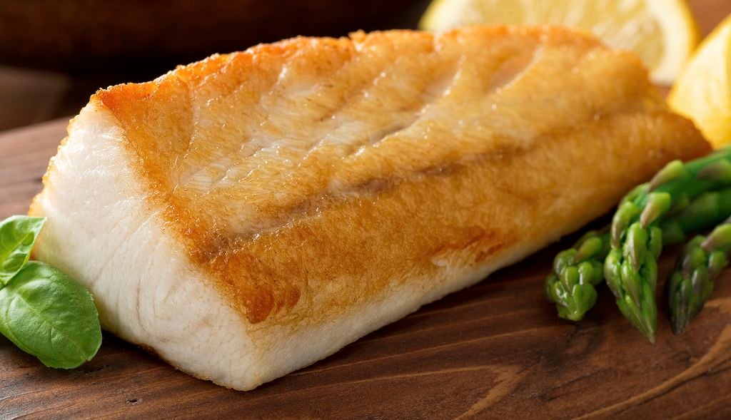 Slices of broiled cobia on the chopping board