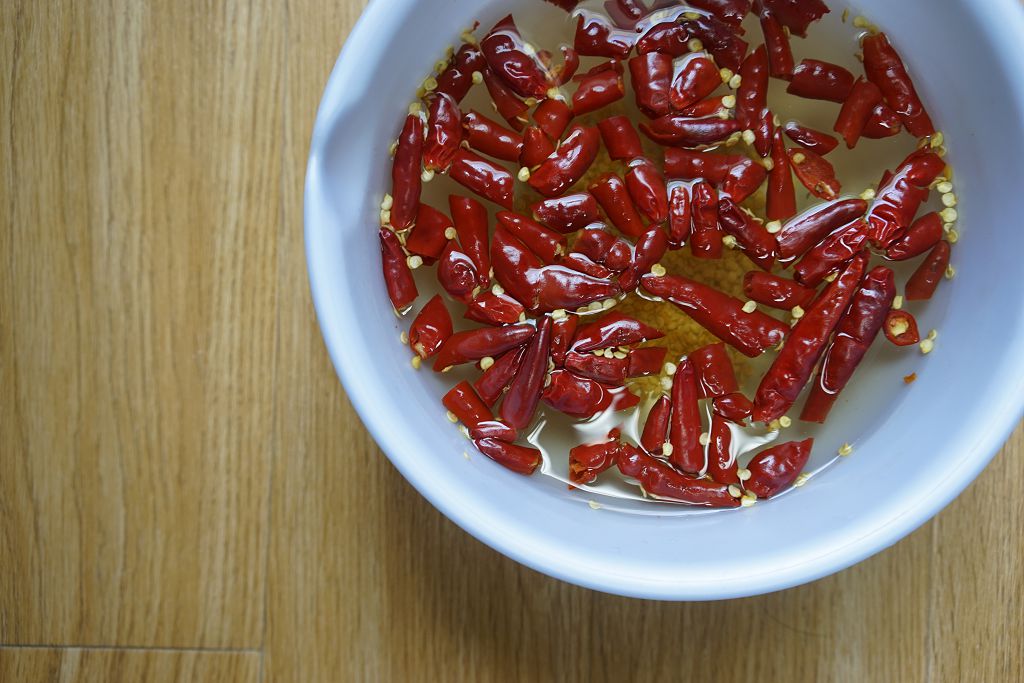 placing the chilies in a heatproof bowl