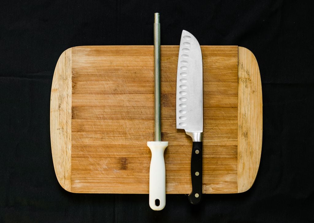 Ceramic Knives and knife sharpener on the chopping board
