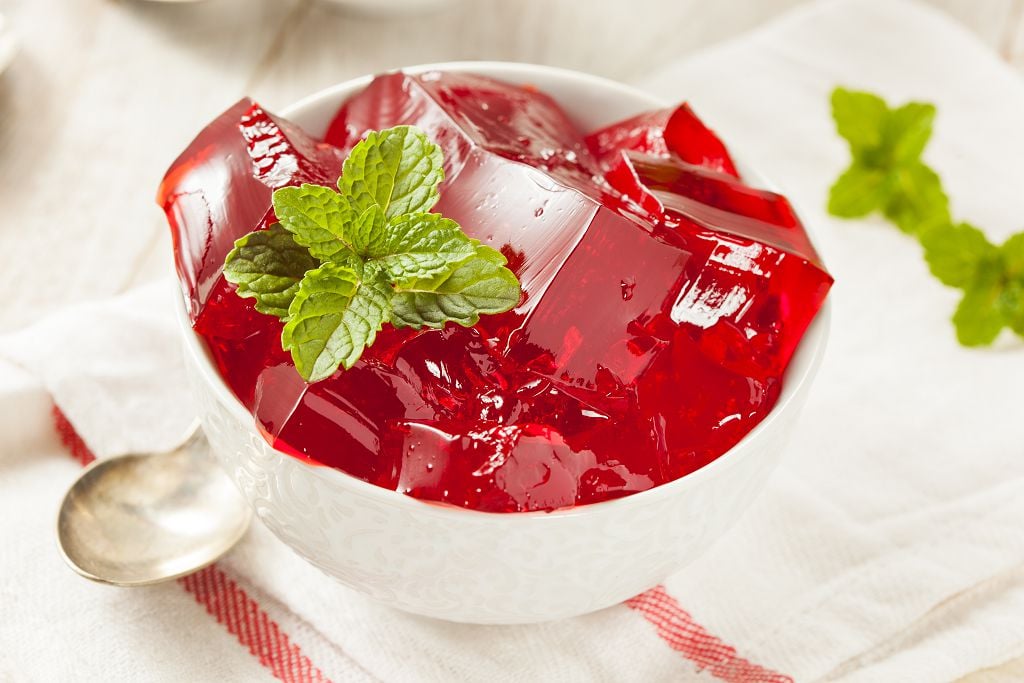 A bowl of Jello and a spoon on the table