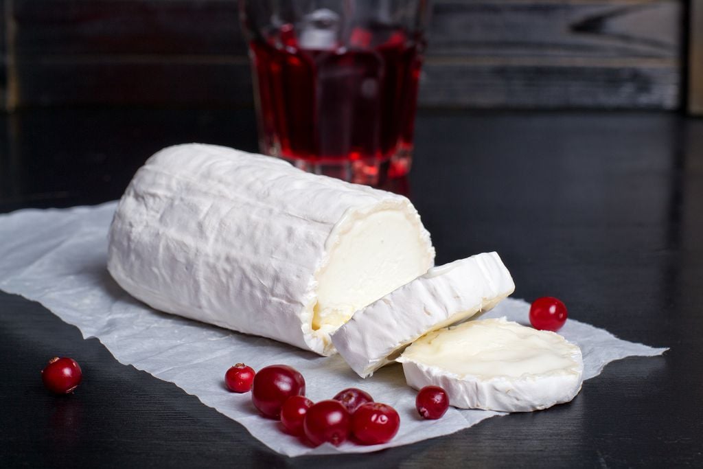 Slices of Goat Cheese and fruits on the table