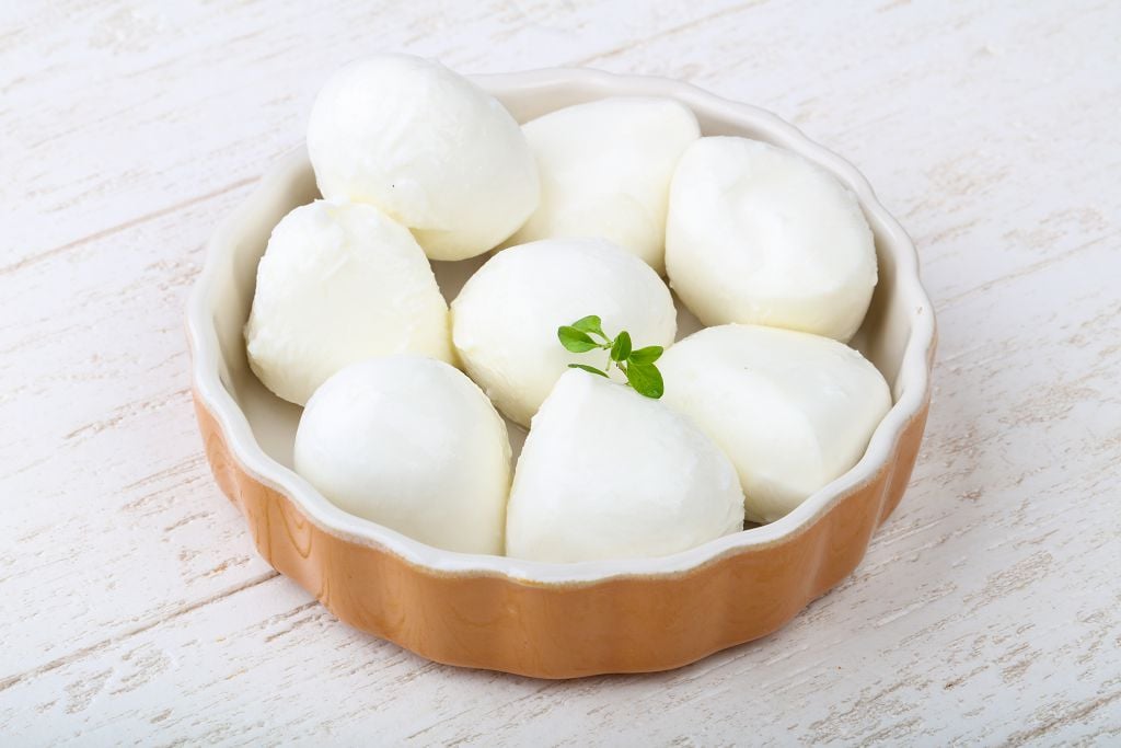 A bowl of Mozzarella Cheese on the table