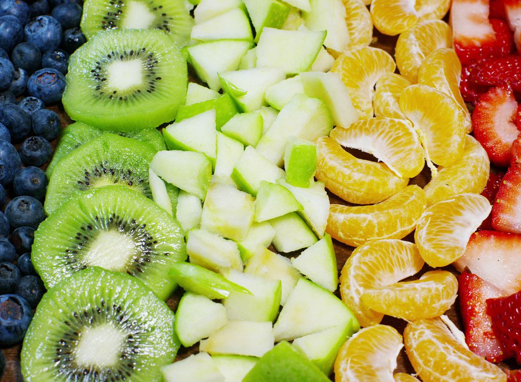 strawberries, raspberries, blueberries, kiwi and orange 