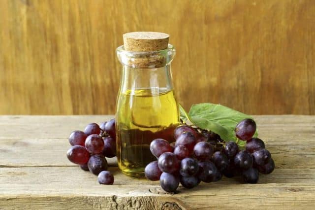 grape seed oil and grape on the table