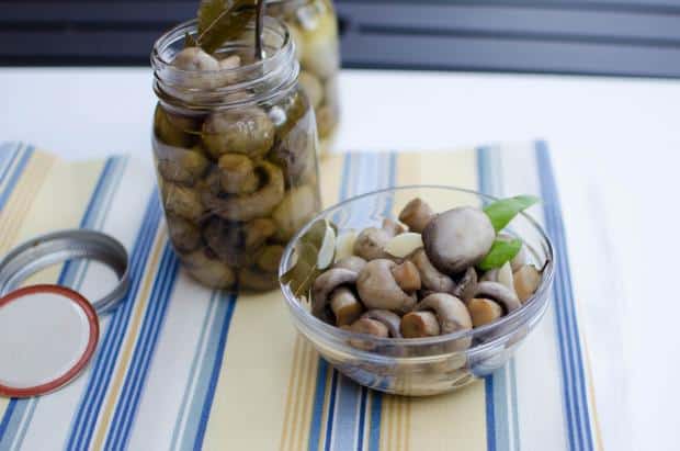 Bottled Mushrooms and a bowl of Mushrooms on the table