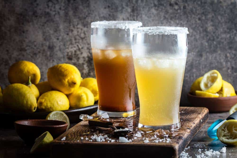 Cups of Beer and Salt on the chopping board and lemons