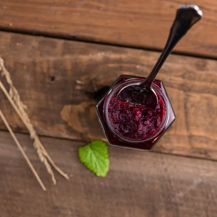 A bottle of Jam and a spoon