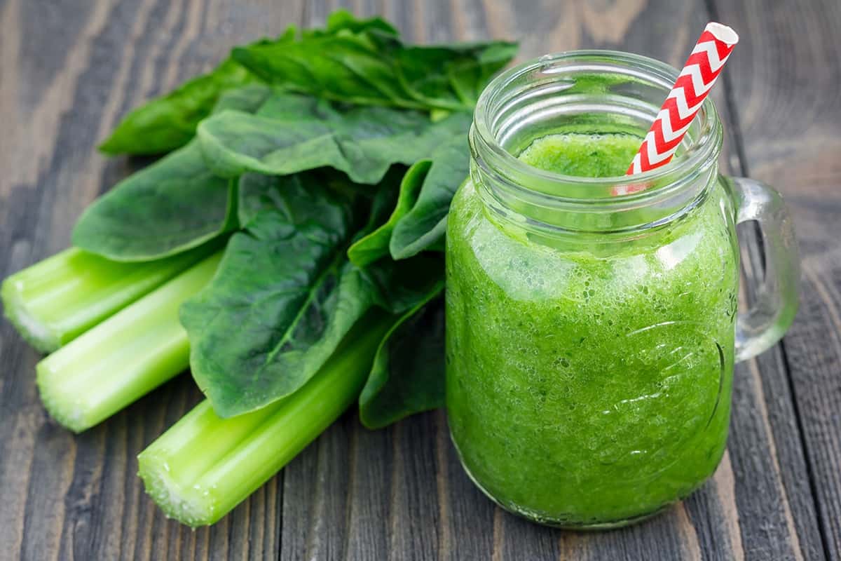 A cup of Spinach-Grapefruit Smoothie and Spinach-Grapefruit on the table