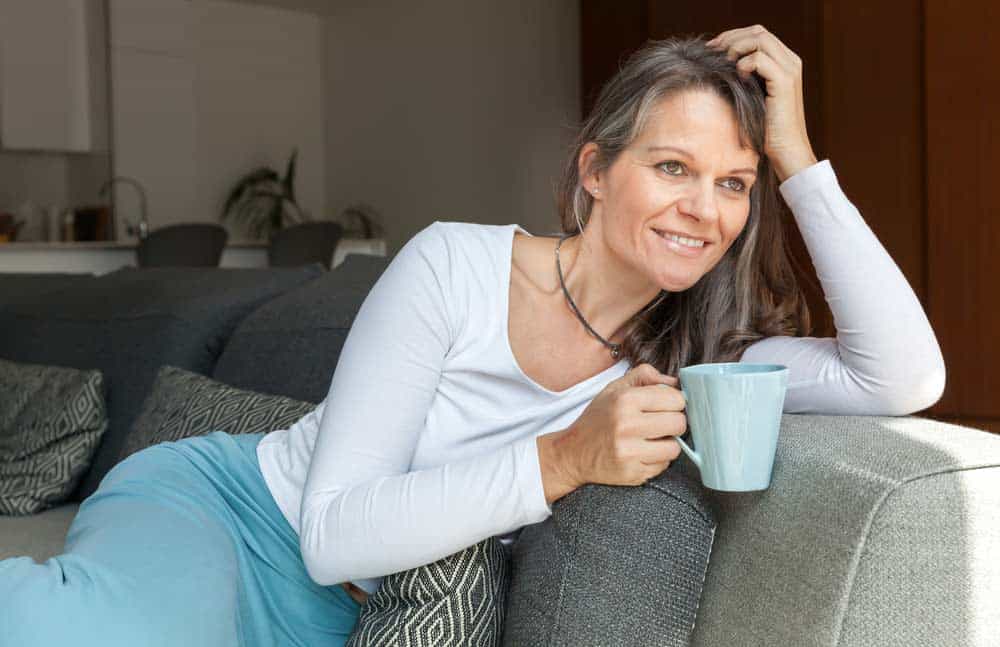 the woman is drinking coffee