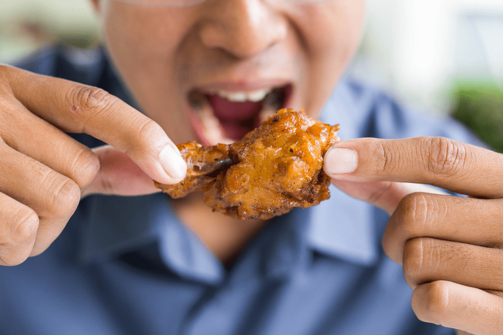 Eating delicious fried chicken wings