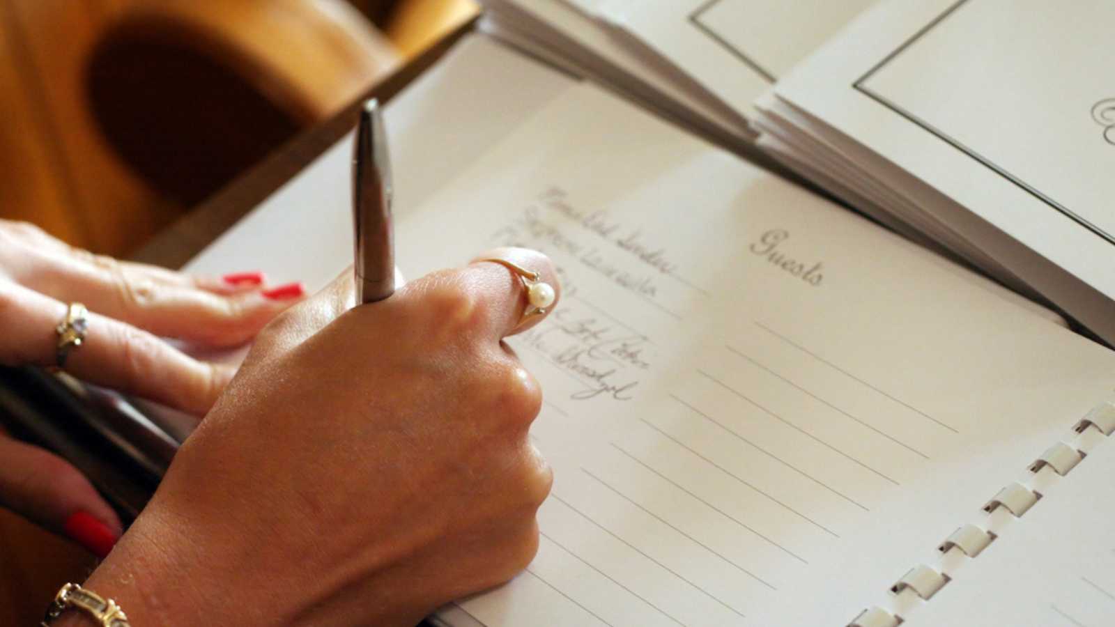 Woman writing down on note