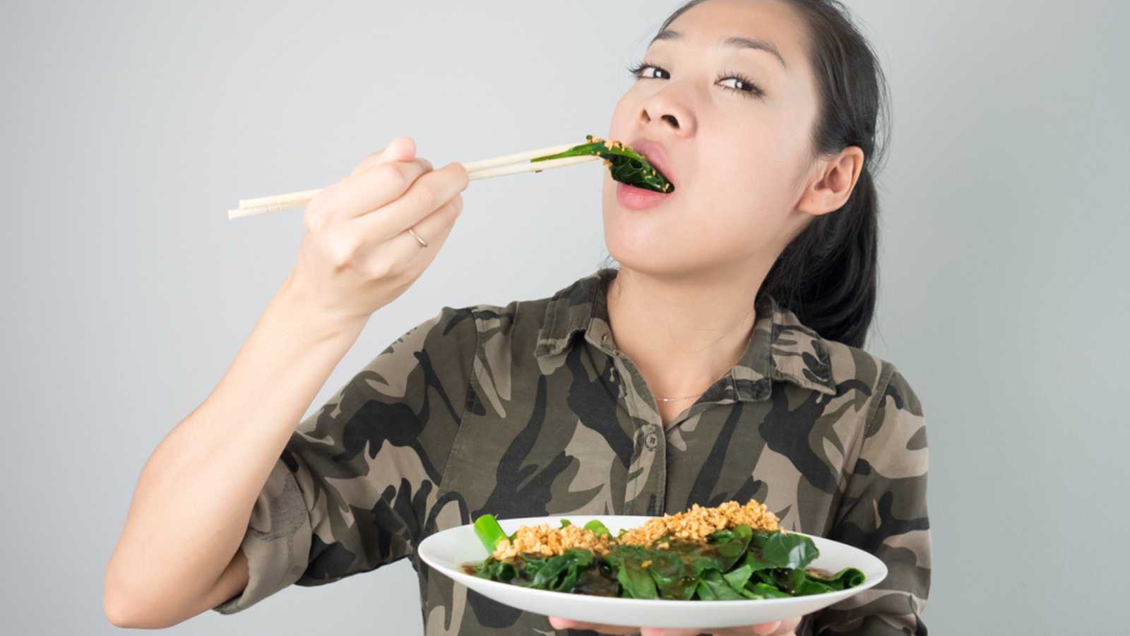 Woman eating kale