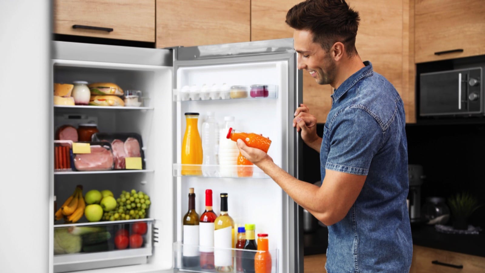 Man eating from fridge