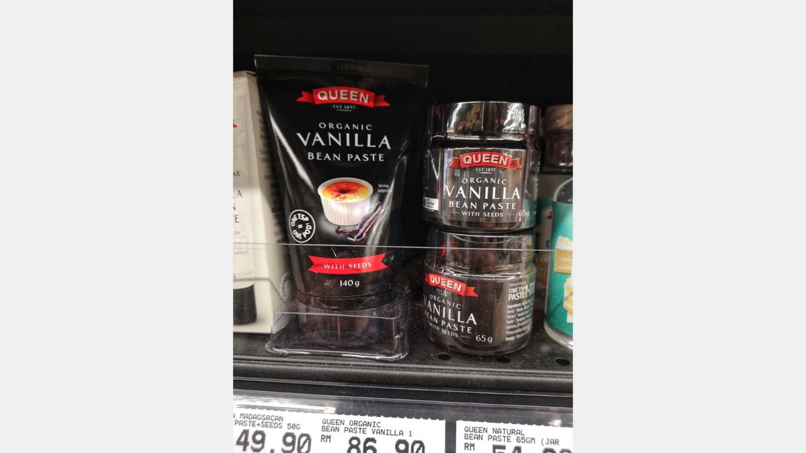 Shah Alam, Malaysia - 25 April 2021 : QUEEN Organic Vanilla Bean Paste with Seeds display for sell on the supermarket shelf with selective focus.