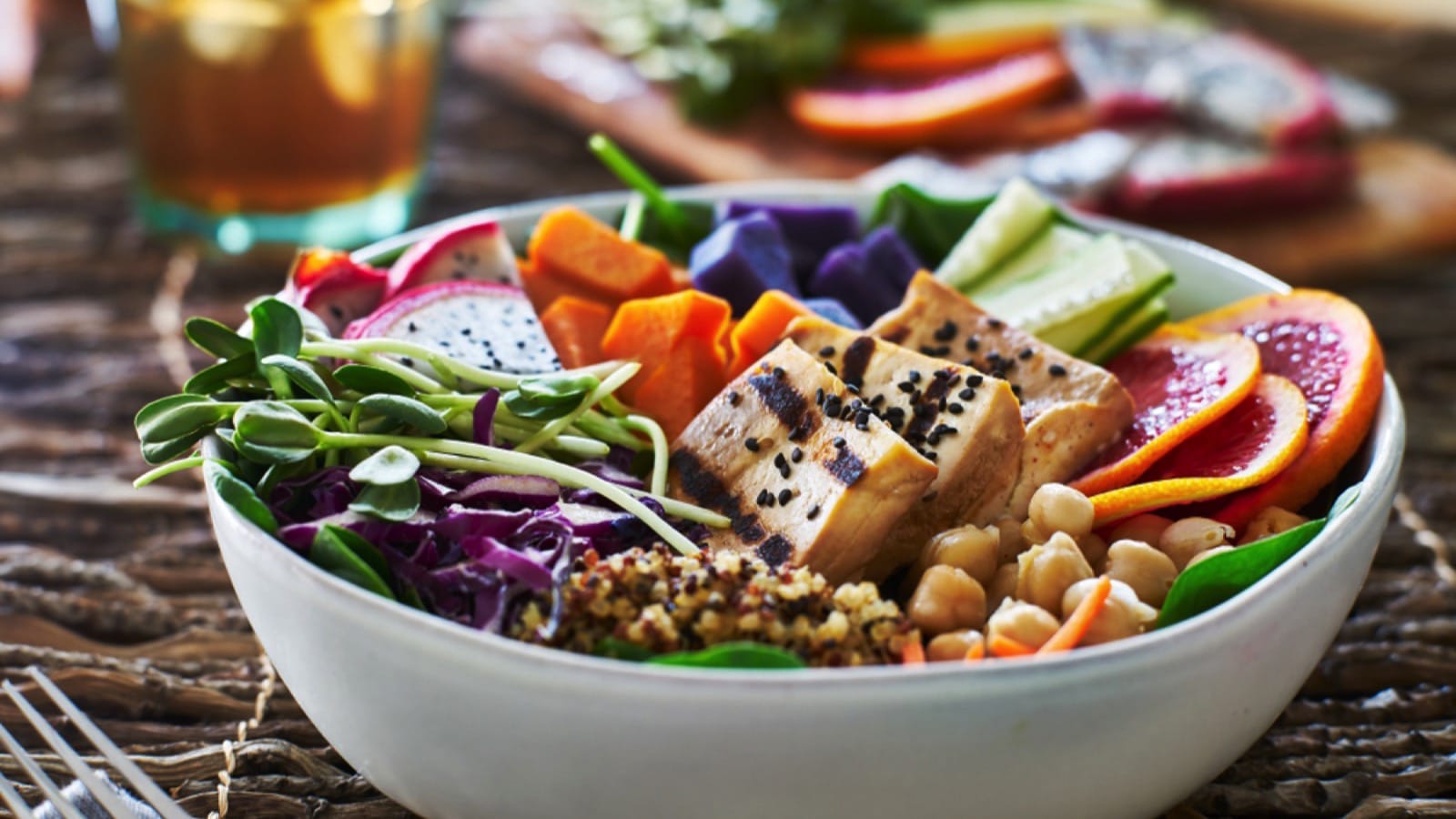 colorful buddha bowl with grilled tofu and pea shoots