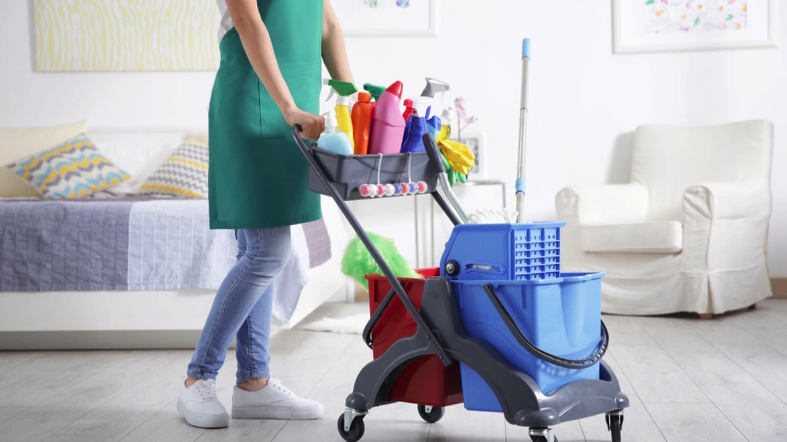 Woman with cleaning trolley