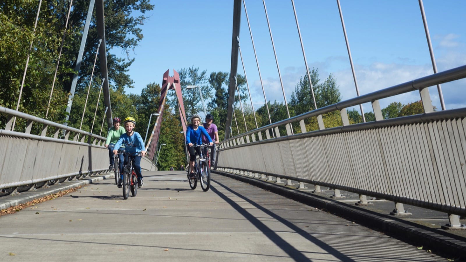 Young family riding in bridge of Eugene, Oregon